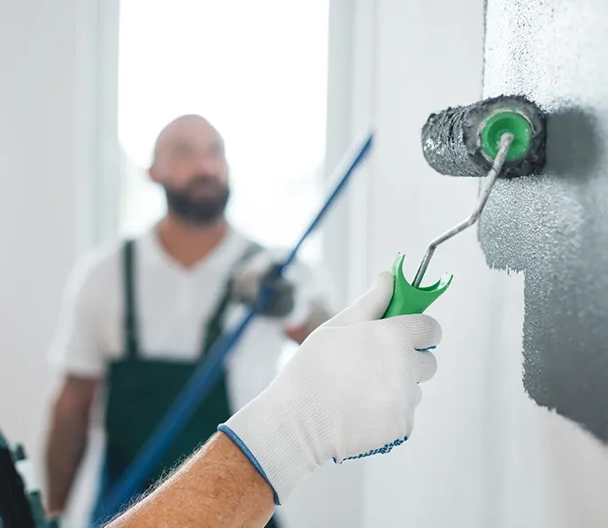 Painter applying fresh paint to a Spokane house exterior