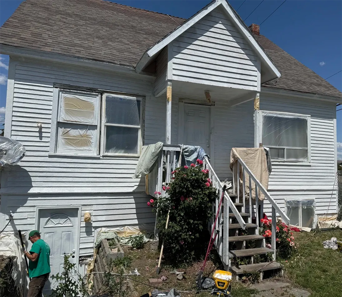 Exterior house painting work in progress on a two-storey home